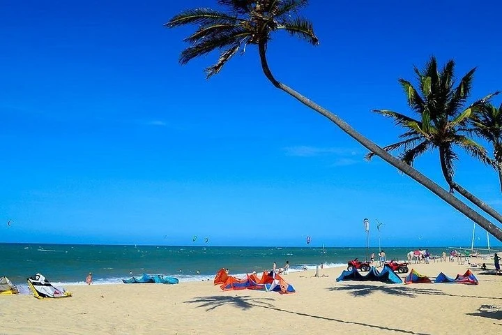 White-sand beach with palms and water-sports equipment — Cumbuco Beach