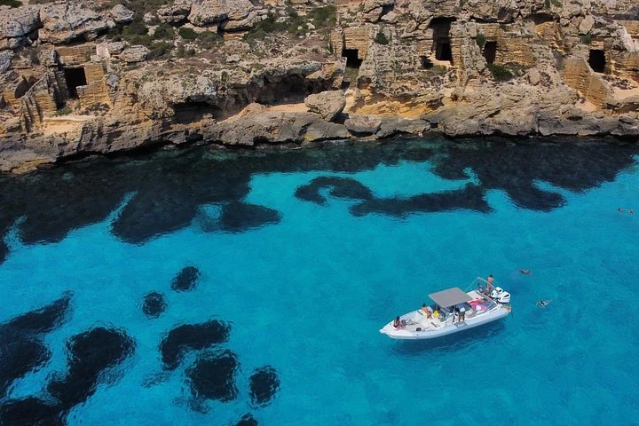 Canot devant les anciennes carrières côtières de Bue Marino à Favignana