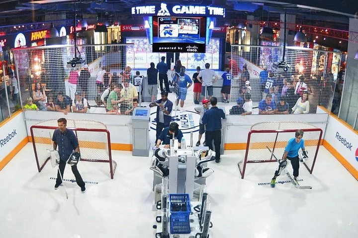 Visitors beside a hockey installation at the Hockey Hall of Fame
