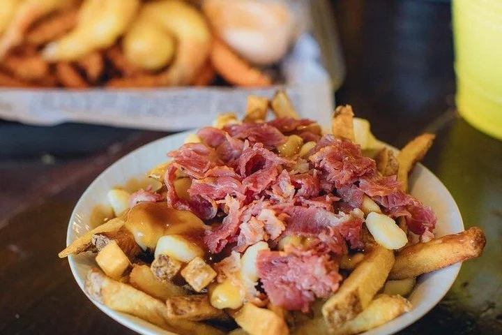 Fries with sauce and toppings on a Toronto food tour
