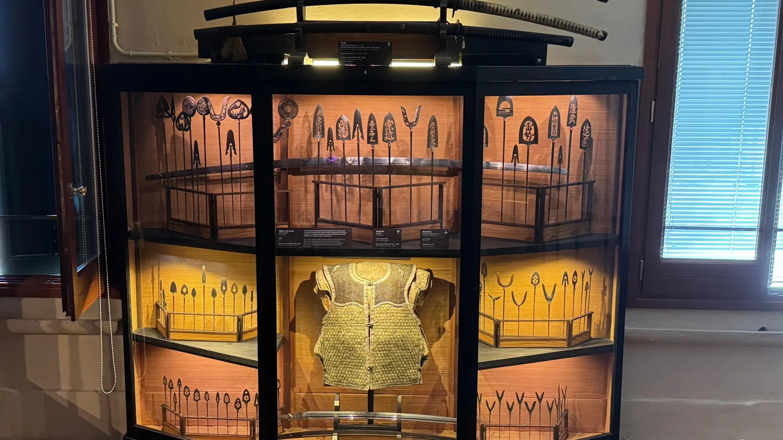 Display case of objects and swords in a Venice museum