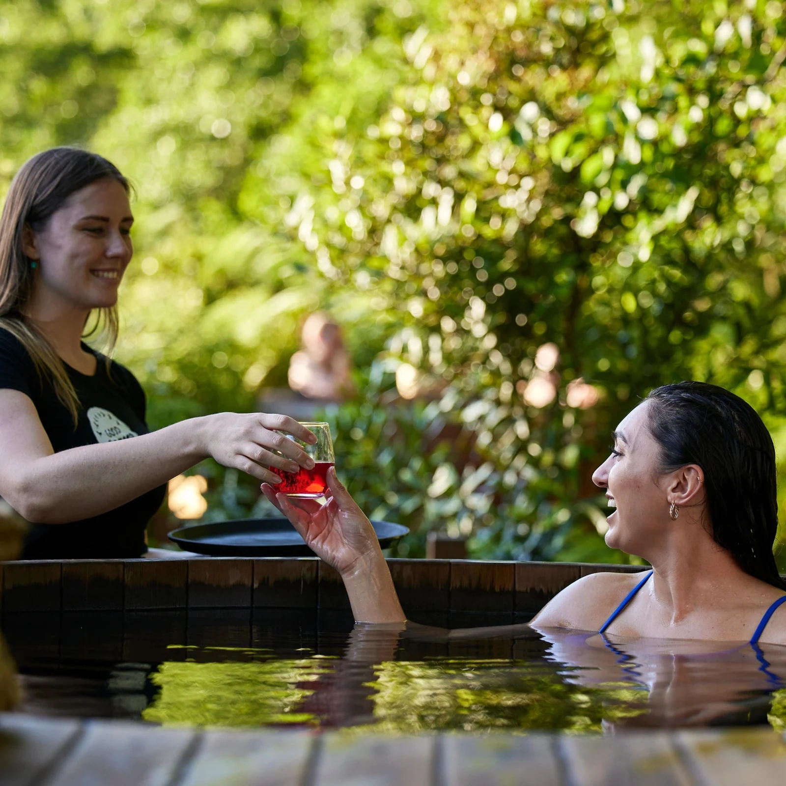 A private cedar hot tub between forest and water