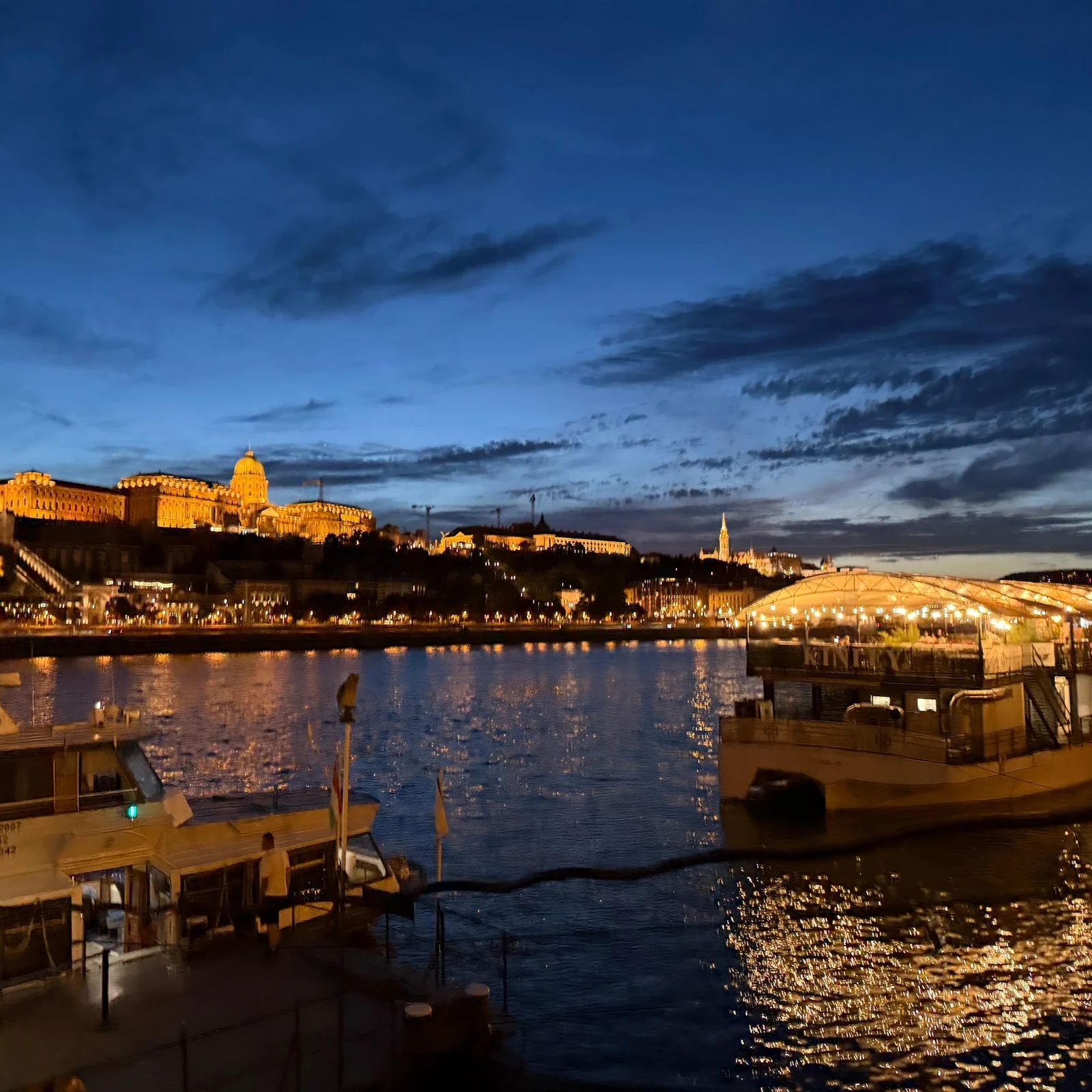See Budapest illuminated from the Danube