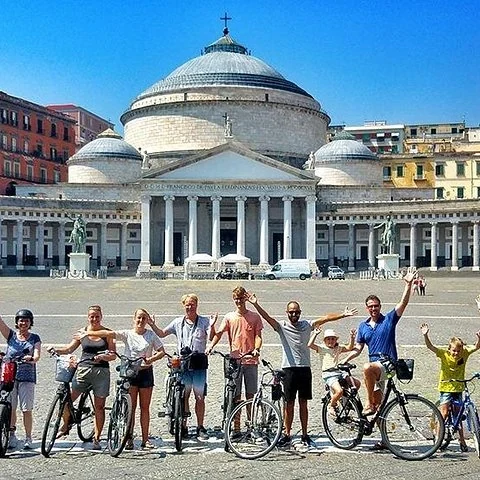 See Naples by bike and stop to understand the city