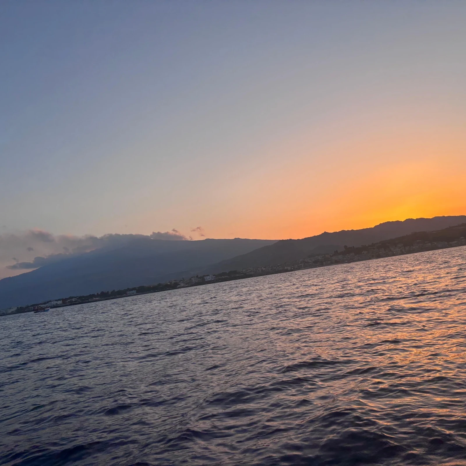 See Taormina from the sea and look for dolphins at sunset
